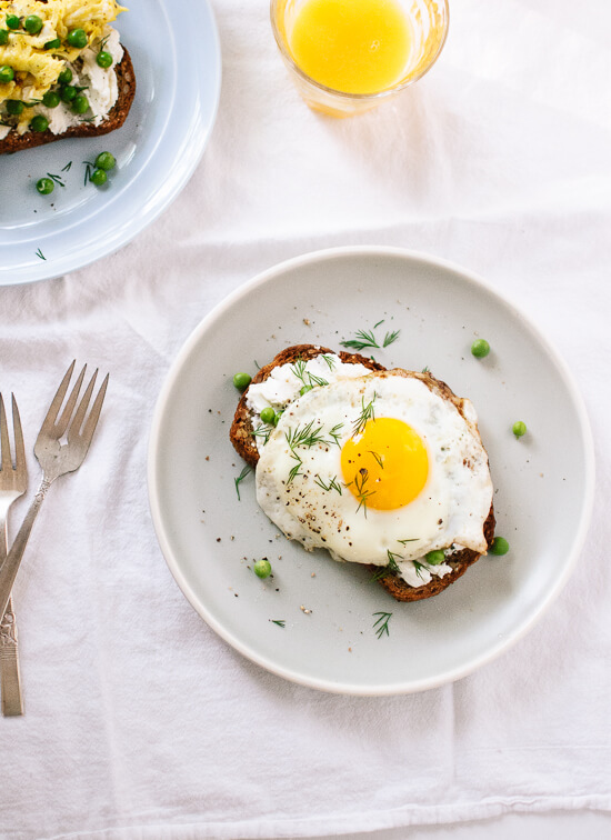 A simple spring meal featuring goat cheese on toast with eggs, fresh peas and herbs - cookieandkate.com
