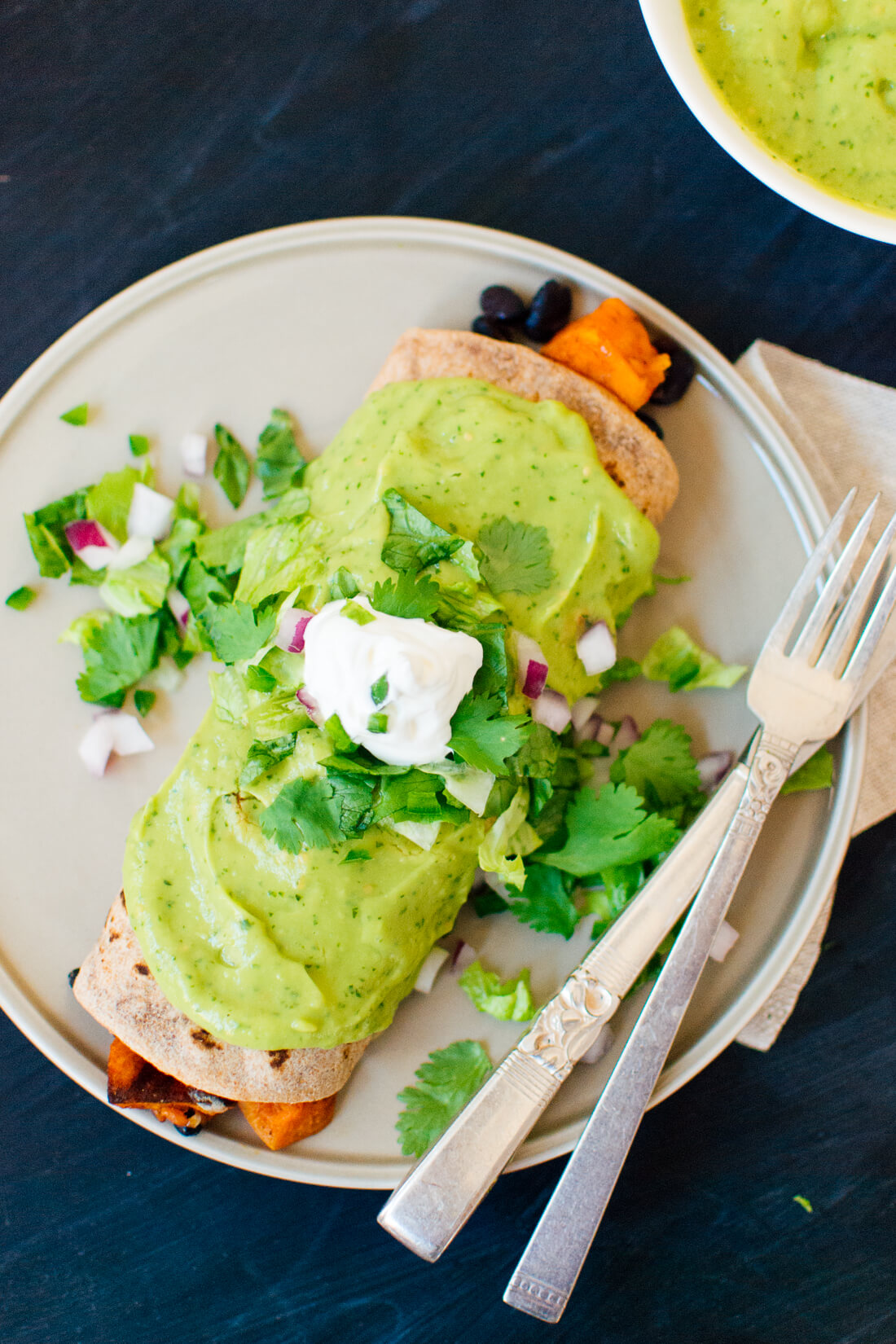 Sweet potato burrito with avocado sauce and sour cream from cookieandkate.com Sweet potato burrito with avocado sauce and sour cream